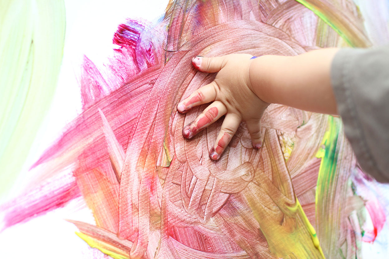 A child using paint to express an idea